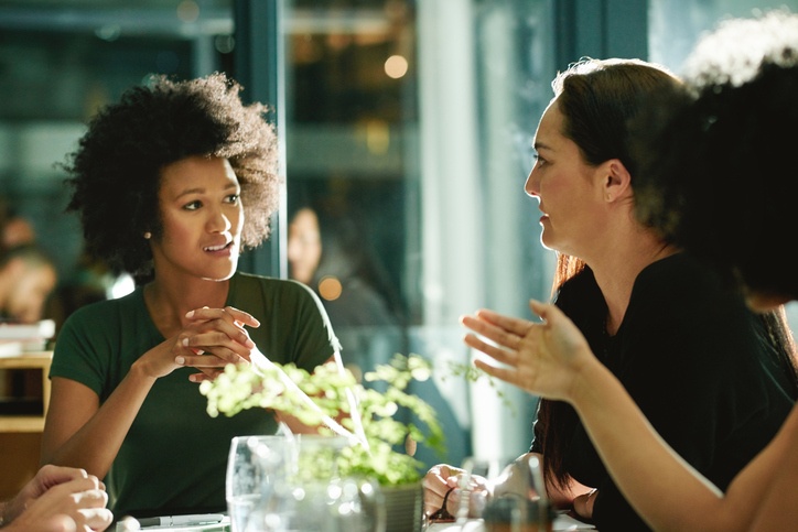 Two female workplace leaders discussing employee expectations at the workplace